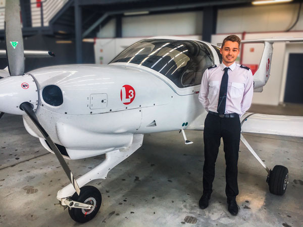 Un étudiant Supméca pose devant un petit avion